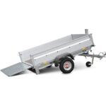 Tilt-bed trailer with ramp lowered, silver metal trailer on a single axle and hitch for towing, ready to load equipment.