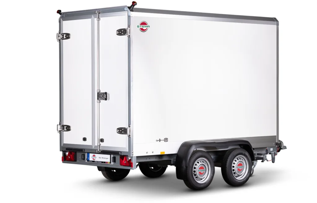 White cargo trailer with dual rear doors, chrome hinges, and a STEM A logo at the back corner; two-axle trailer with black fenders and rear lights visible