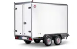 White cargo trailer with dual rear doors, chrome hinges, and a STEM A logo at the back corner; two-axle trailer with black fenders and rear lights visible