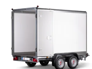 Silver cargo trailer with rear doors open, showing a large white interior, mounted on a dual-axle chassis with red taillights and a small license plate area at the back.