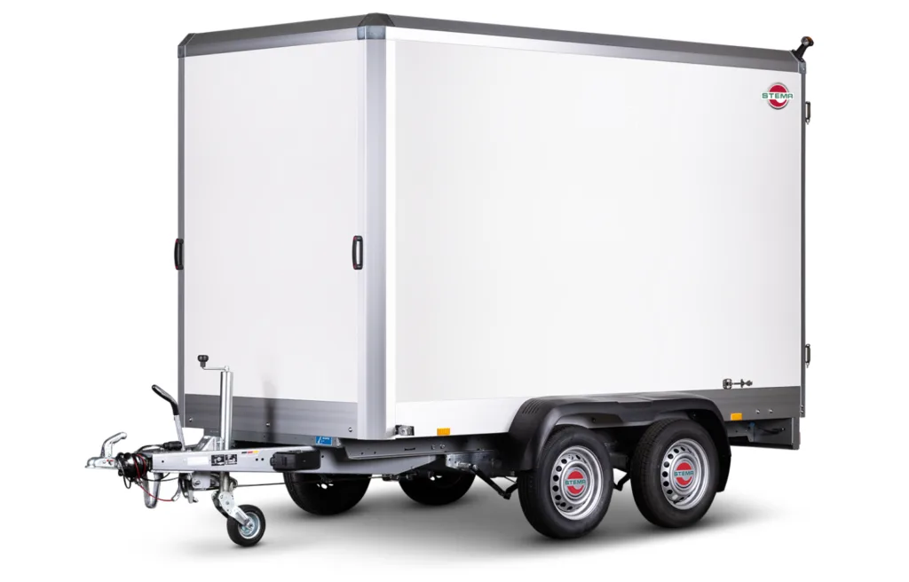 White enclosed cargo trailer with dual axles and a front hitch, STEMA logo visible on the side.