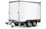 White enclosed cargo trailer with dual axles and a front hitch, STEMA logo visible on the side.