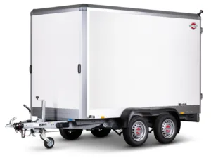 White enclosed cargo trailer with dual axles and a front hitch, STEMA logo visible on the side.