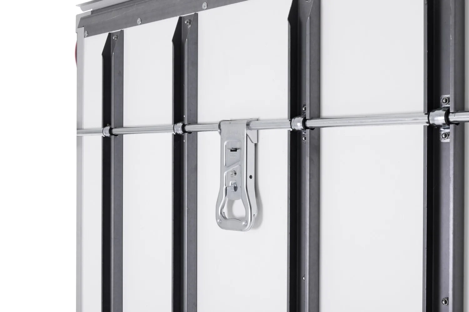 Close-up of a metal latch and horizontal locking bar securing a white industrial door.